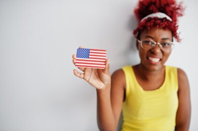 african-american-woman-with-afro-hair-wear-yellow-singlet-eyeglasses-hold-usa-flag-isolated-white-background_627829-11034